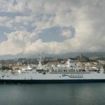 white cruise ship on the sea under the cloudy sky