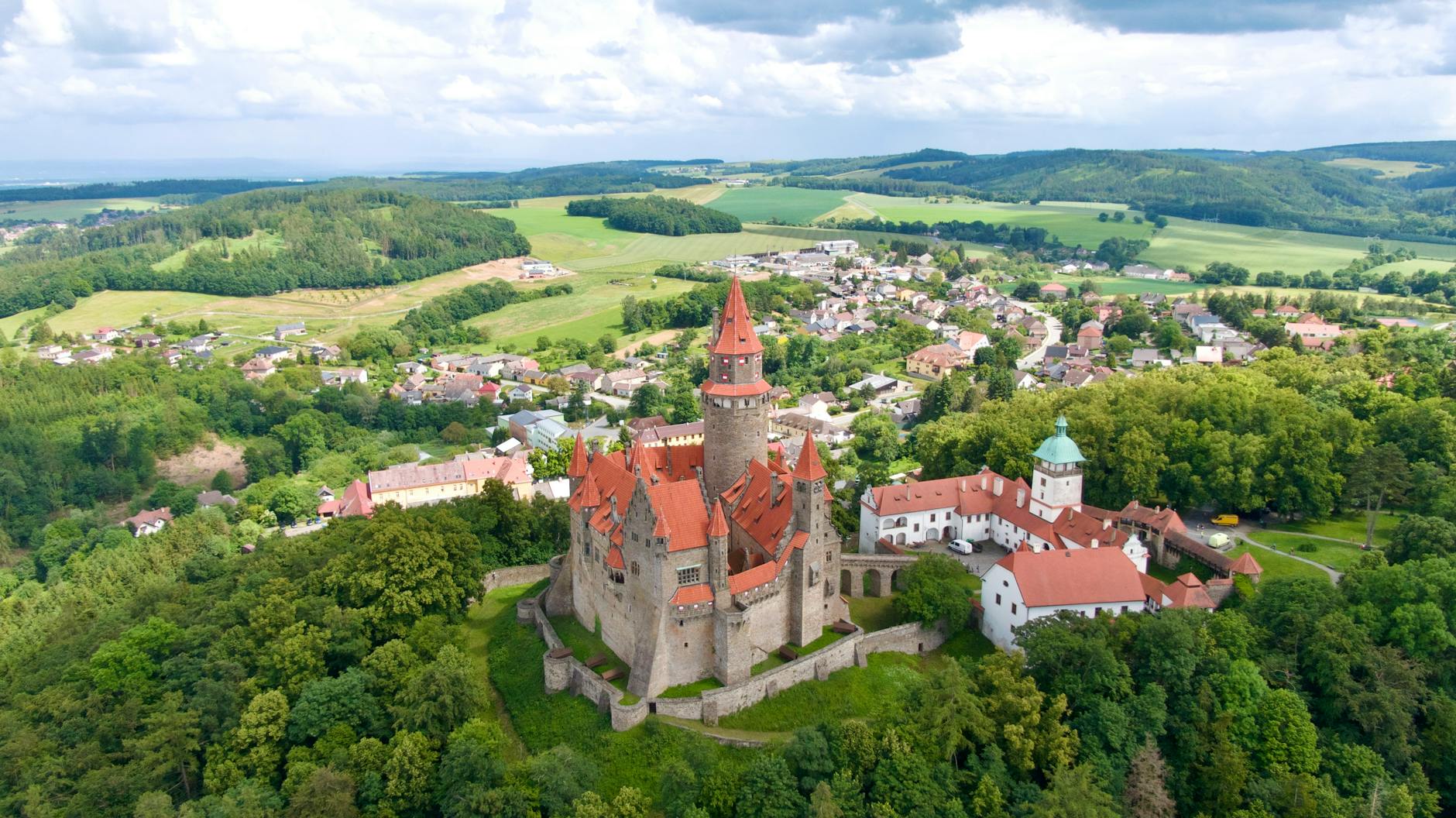 aerial view of the castle on a hill above the village of bouzov in the czech republic